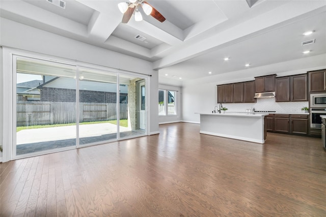 interior space featuring beamed ceiling, dark hardwood / wood-style floors, and ceiling fan