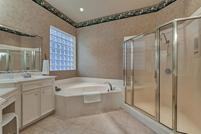 bathroom with tile patterned floors, vanity, and shower with separate bathtub