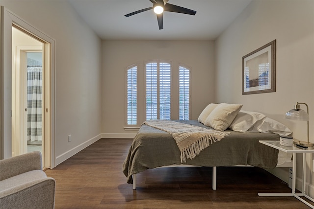 bedroom with dark hardwood / wood-style floors, ensuite bath, and ceiling fan