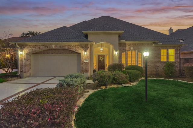 view of front of property with a lawn and a garage