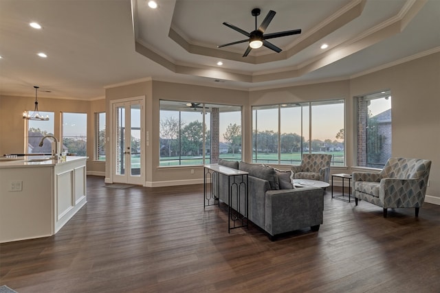 living room featuring plenty of natural light, dark hardwood / wood-style flooring, and ornamental molding