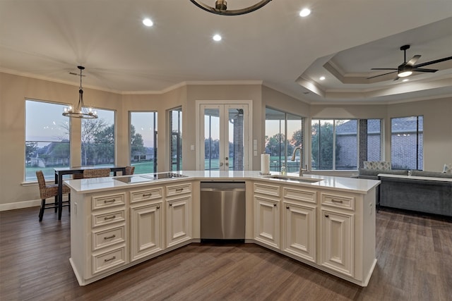 kitchen with dishwasher, decorative light fixtures, a center island with sink, and sink