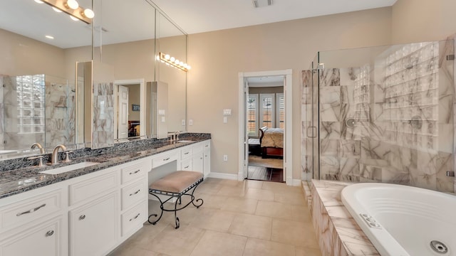 bathroom featuring independent shower and bath, vanity, and tile patterned floors