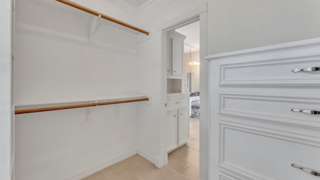 spacious closet featuring light tile patterned flooring