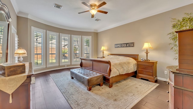 bedroom featuring hardwood / wood-style flooring, ornamental molding, and ceiling fan