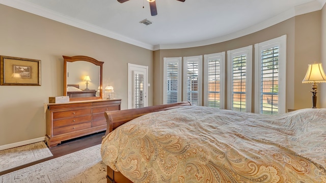 bedroom featuring crown molding, ceiling fan, and hardwood / wood-style floors