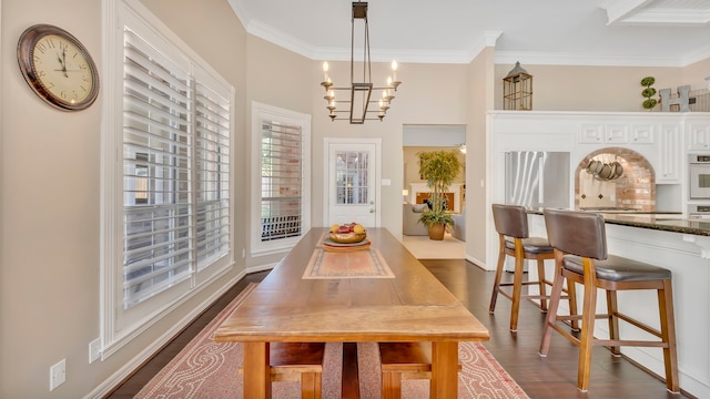 dining space with dark hardwood / wood-style flooring, a notable chandelier, and crown molding