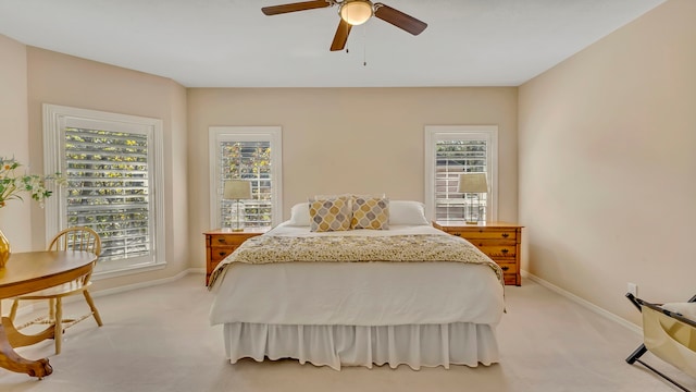 bedroom featuring light colored carpet and ceiling fan