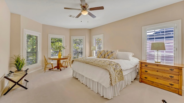 bedroom featuring ceiling fan and light carpet