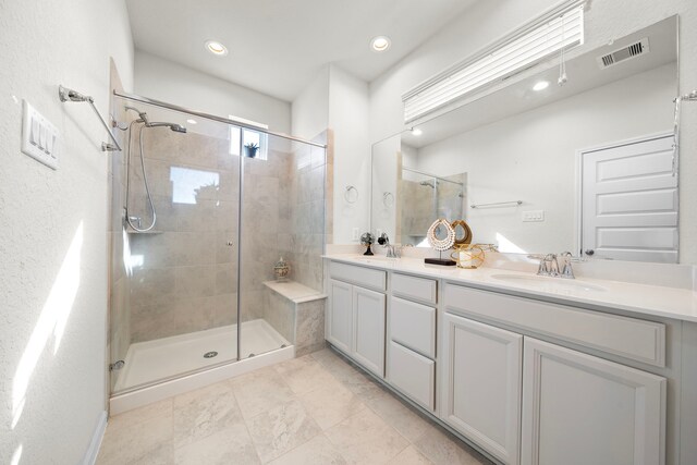 bathroom featuring vanity and a shower with door