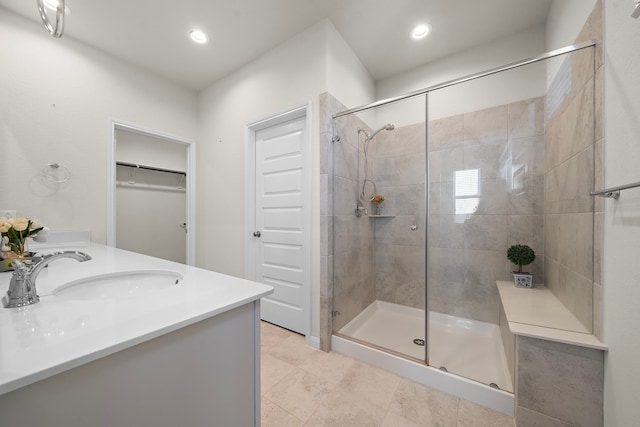 bathroom featuring tile patterned flooring, vanity, and an enclosed shower