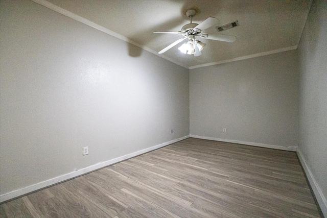 empty room featuring hardwood / wood-style flooring, ceiling fan, and ornamental molding