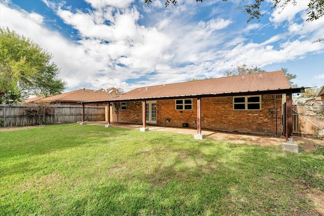 back of house featuring a yard and a patio