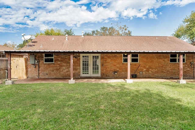 back of property featuring a yard and a patio