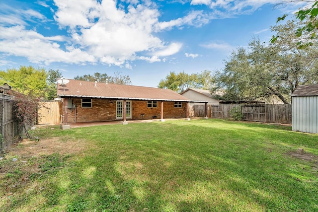 back of property featuring a yard and a patio