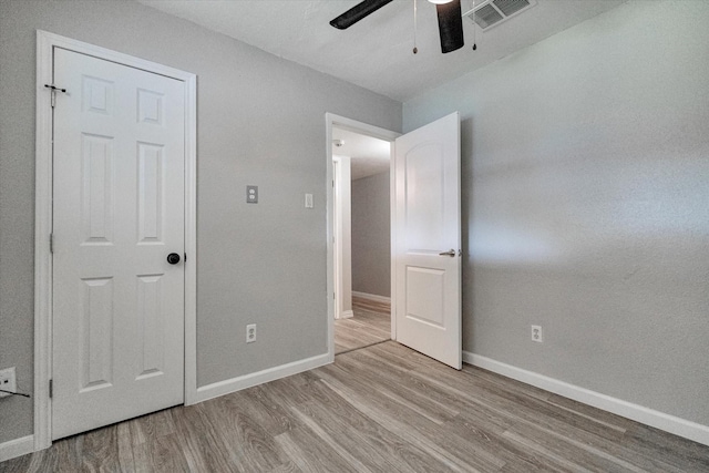 unfurnished bedroom featuring ceiling fan and light hardwood / wood-style floors