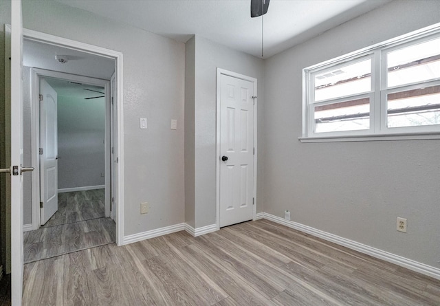 unfurnished bedroom featuring ceiling fan and light wood-type flooring