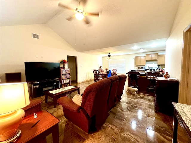 living room featuring ceiling fan and lofted ceiling