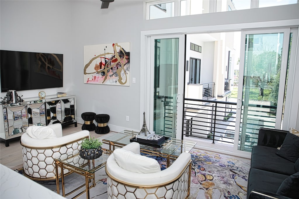 living room with wood-type flooring and a high ceiling