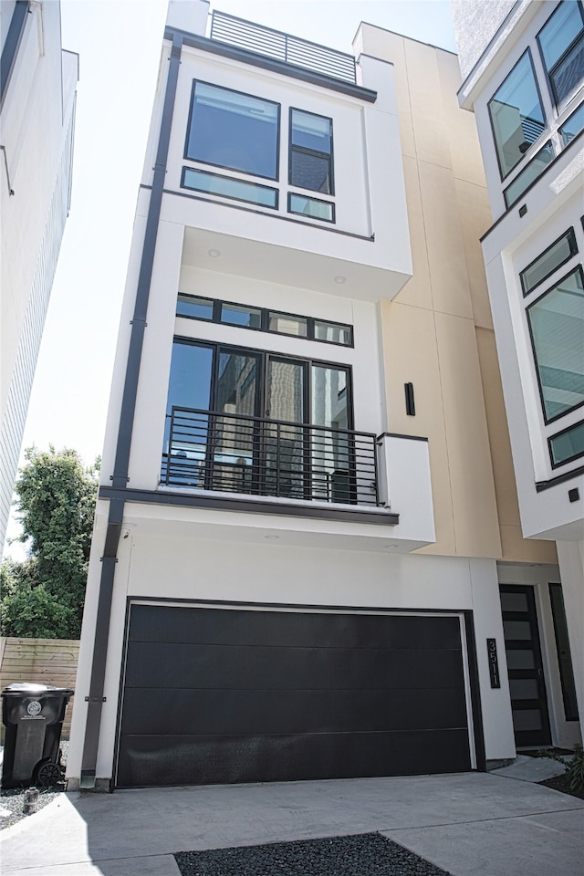 view of front of property with a garage and a balcony