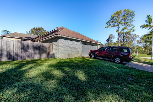 view of home's exterior with a lawn and a garage