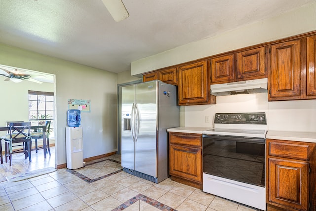 kitchen with stainless steel fridge, a textured ceiling, ceiling fan, electric stove, and light tile patterned flooring