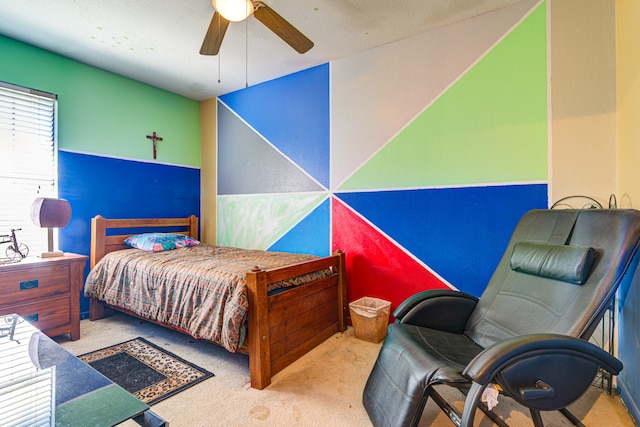 carpeted bedroom with ceiling fan and a textured ceiling