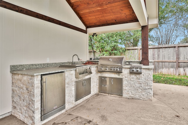 view of patio featuring area for grilling and sink