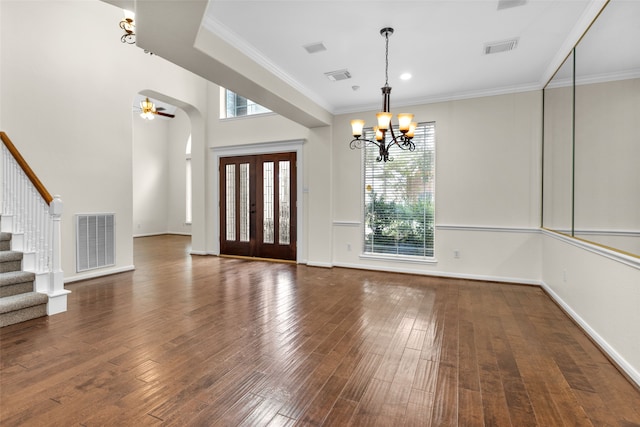 foyer entrance with ceiling fan with notable chandelier, dark hardwood / wood-style flooring, and crown molding