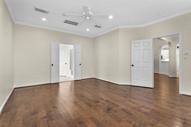 spare room with ceiling fan, crown molding, and dark wood-type flooring