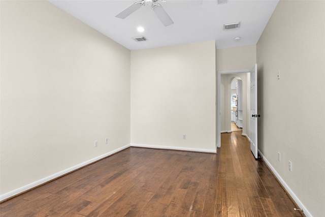 spare room featuring ceiling fan and dark hardwood / wood-style flooring