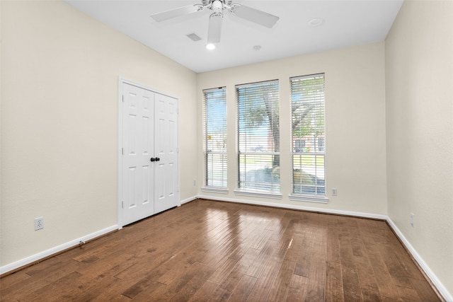 spare room featuring ceiling fan, plenty of natural light, and hardwood / wood-style flooring