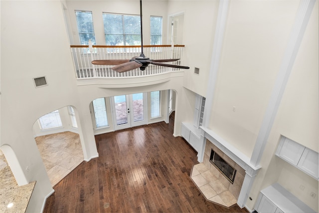 foyer entrance with plenty of natural light, dark hardwood / wood-style flooring, and a towering ceiling