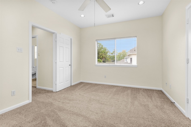 carpeted empty room featuring ceiling fan