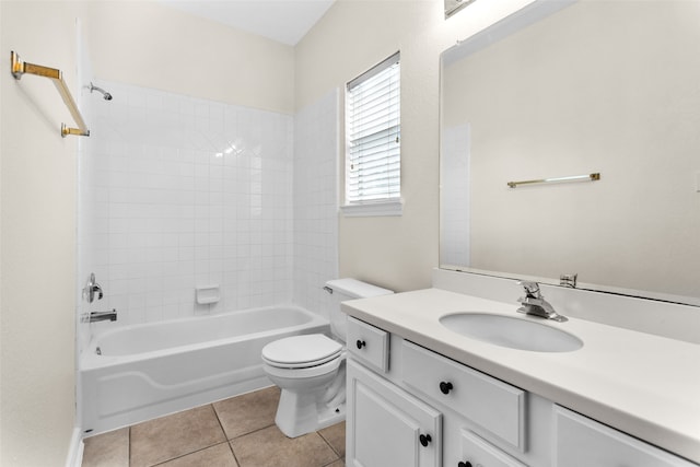 full bathroom featuring tile patterned floors, vanity, tiled shower / bath, and toilet