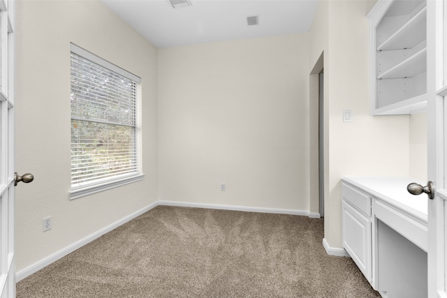 spare room with light carpet