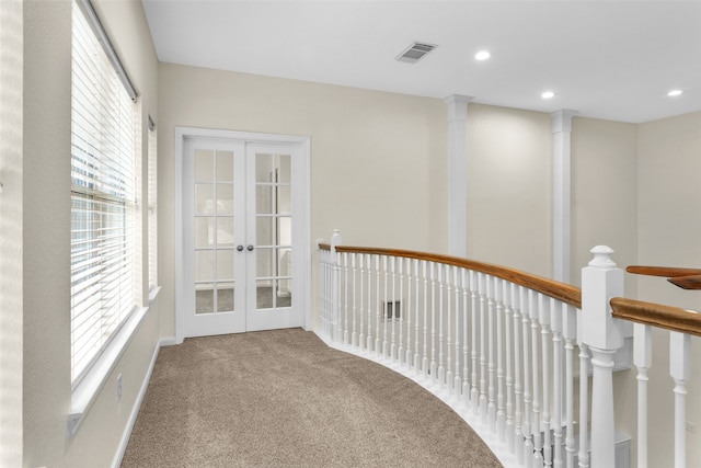 corridor featuring french doors and carpet floors