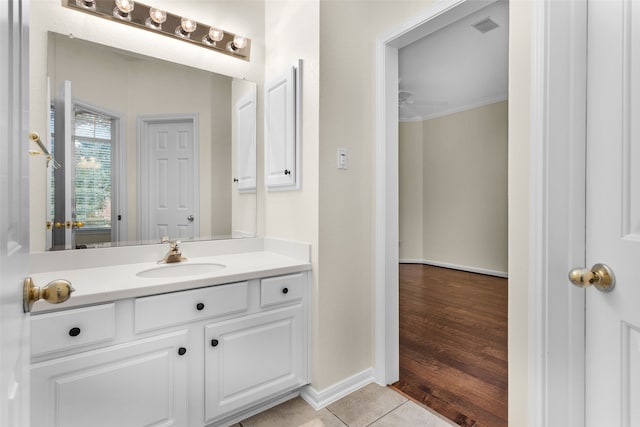 bathroom with hardwood / wood-style floors, ceiling fan, crown molding, and vanity