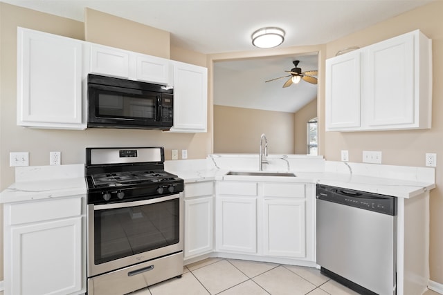 kitchen featuring appliances with stainless steel finishes, vaulted ceiling, ceiling fan, sink, and white cabinetry