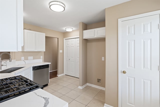 kitchen with dishwasher, white cabinets, light stone countertops, and sink