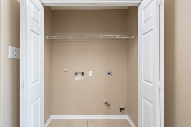 washroom with hookup for an electric dryer, washer hookup, gas dryer hookup, and light tile patterned flooring