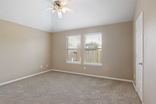 empty room featuring ceiling fan, carpet, and lofted ceiling