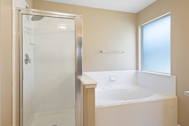 bathroom featuring shower with separate bathtub