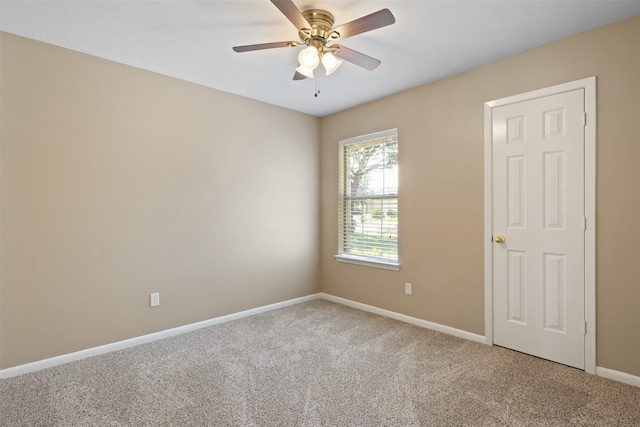 empty room with carpet flooring and ceiling fan