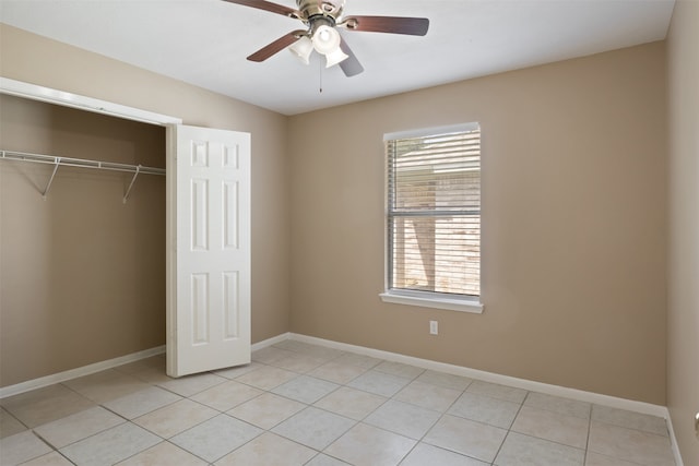 unfurnished bedroom featuring ceiling fan, a closet, and light tile patterned floors