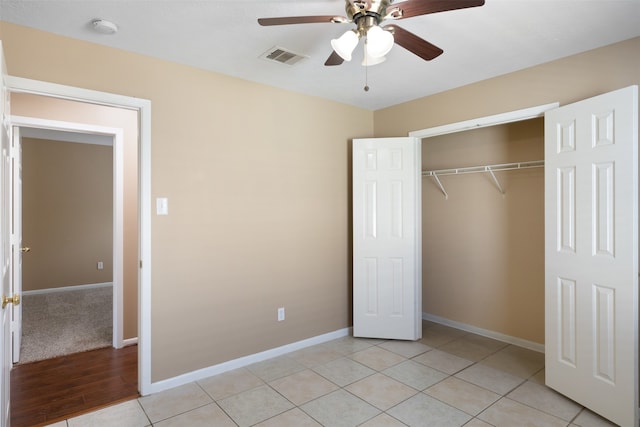 unfurnished bedroom with ceiling fan, light hardwood / wood-style flooring, and a closet