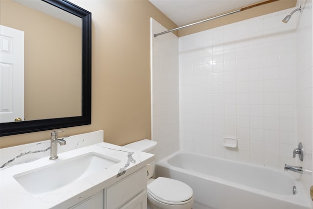 full bathroom with tiled shower / bath, vanity, and toilet