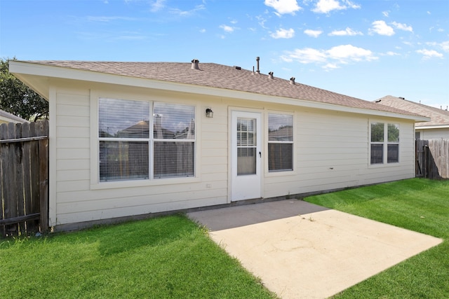 back of house featuring a yard and a patio