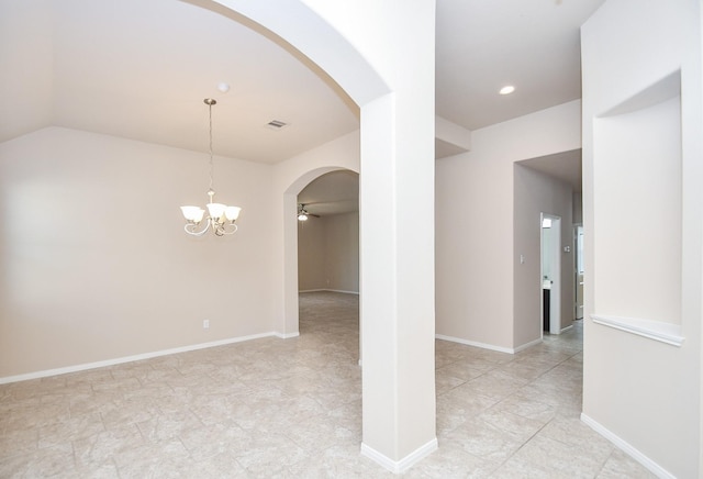 unfurnished room featuring lofted ceiling and ceiling fan with notable chandelier