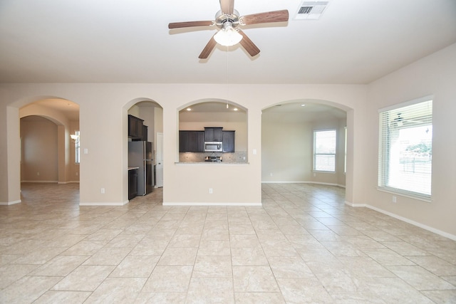 unfurnished living room with ceiling fan and light tile patterned floors